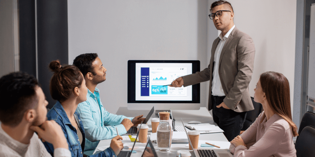 A man presents to an audience, engaging them with his speech and visual aids.
