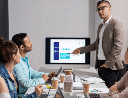 A man presents to an audience, engaging them with his speech and visual aids.