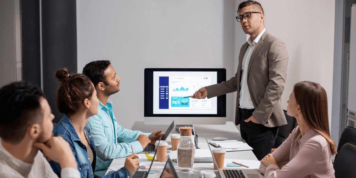 A man presents to an audience, engaging them with his speech and visual aids.